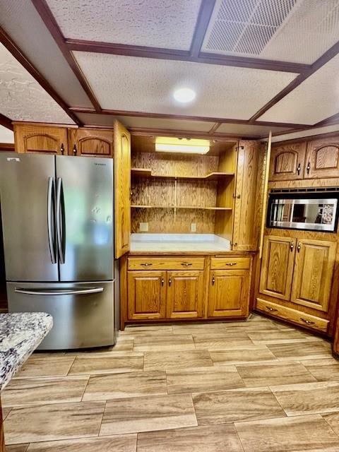 kitchen featuring a textured ceiling and stainless steel appliances