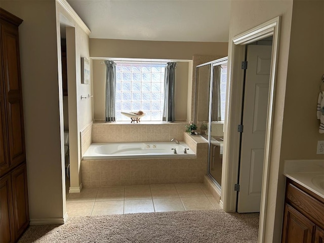 bathroom with tile patterned flooring, vanity, and shower with separate bathtub