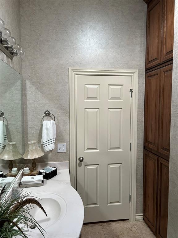 bathroom with tile patterned flooring and sink