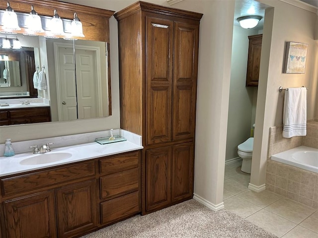 bathroom featuring tiled tub, tile patterned flooring, vanity, and toilet