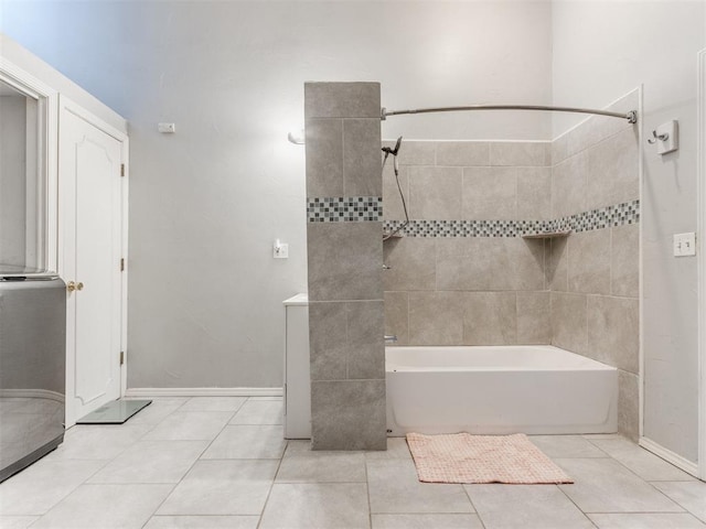 bathroom featuring tiled shower / bath combo and tile patterned flooring