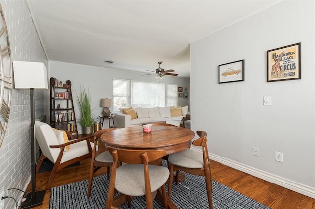 dining room with ceiling fan and hardwood / wood-style flooring