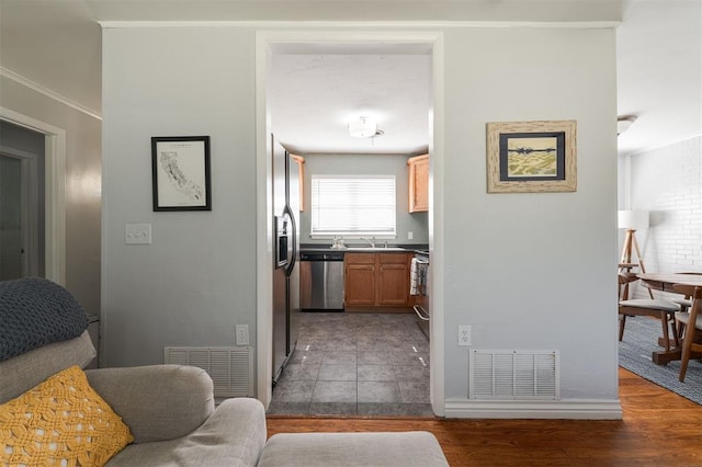 hallway featuring sink, dark wood-type flooring, and ornamental molding