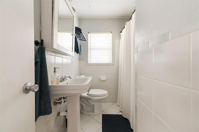 bathroom featuring tile walls, ornamental molding, tile patterned floors, and toilet