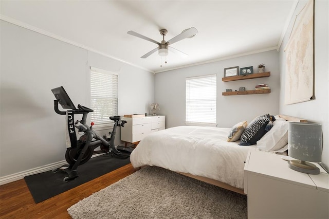 bedroom featuring ceiling fan, dark wood-type flooring, and ornamental molding