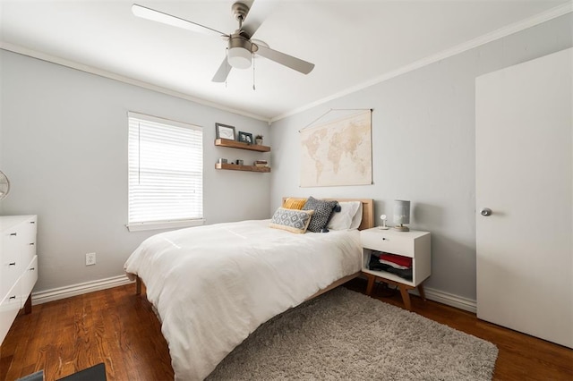 bedroom featuring ornamental molding, dark wood-type flooring, and ceiling fan