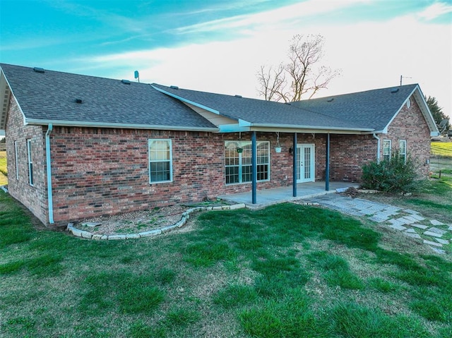 back of property featuring a patio area and a yard