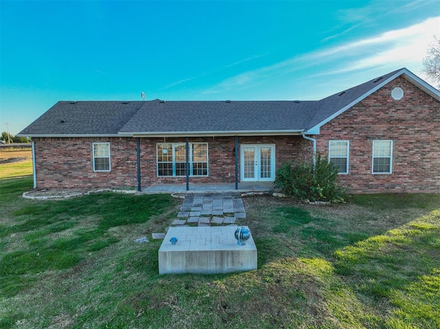 rear view of property with a patio area and a lawn