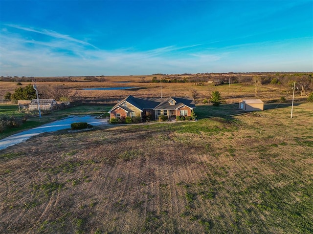 birds eye view of property with a rural view