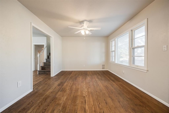 unfurnished room featuring dark hardwood / wood-style floors and ceiling fan