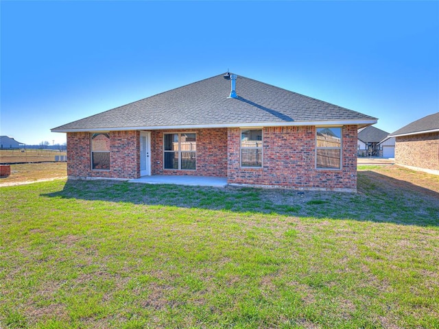 back of property featuring a lawn and a patio area