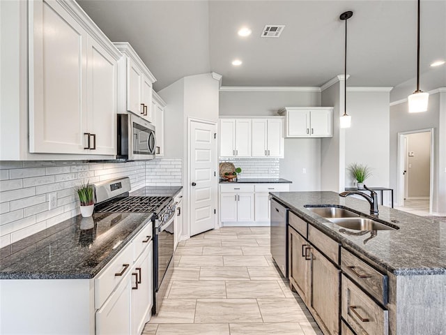 kitchen featuring stainless steel appliances, sink, a center island with sink, white cabinets, and hanging light fixtures