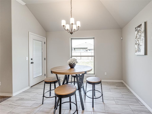 dining space with a notable chandelier and vaulted ceiling