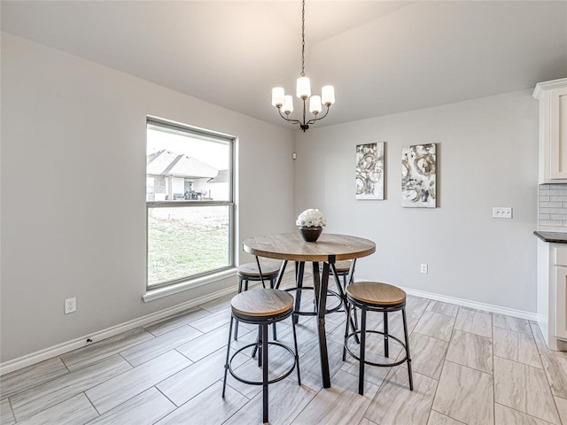 dining area with an inviting chandelier