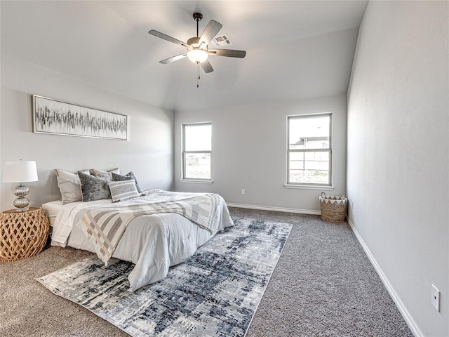 carpeted bedroom featuring multiple windows and ceiling fan