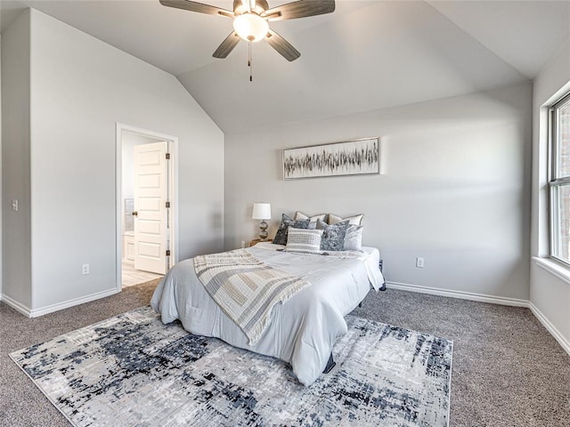 bedroom with multiple windows, ceiling fan, ensuite bath, and lofted ceiling