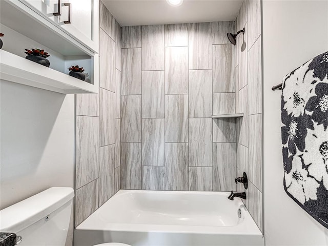 bathroom with tiled shower / bath combo and toilet