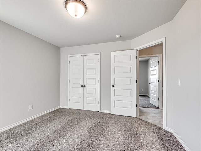 unfurnished bedroom with carpet and a closet