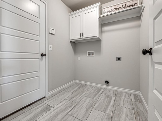 clothes washing area featuring electric dryer hookup, cabinets, and washer hookup