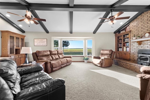 living room featuring carpet flooring, a wood stove, ceiling fan, and lofted ceiling with beams