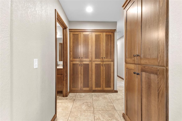 hall with light tile patterned flooring