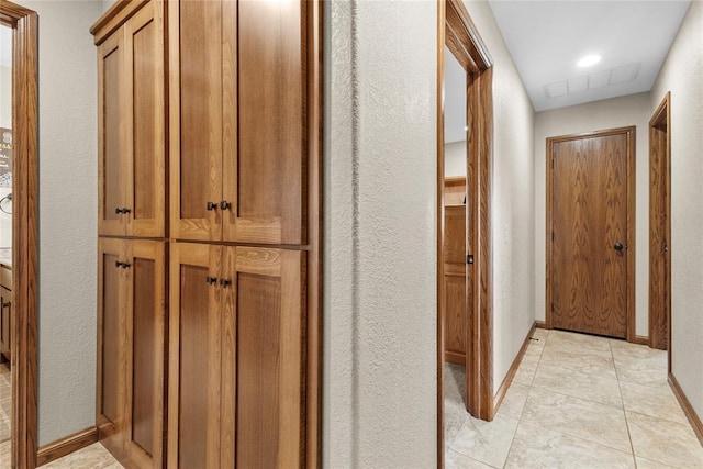 hall featuring light tile patterned floors