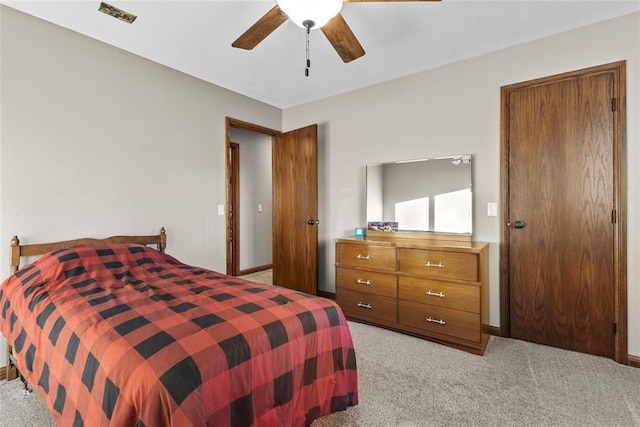 bedroom with ceiling fan and light colored carpet