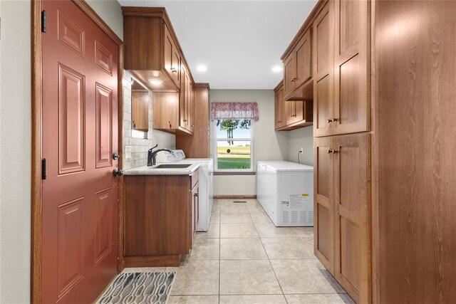 kitchen with decorative backsplash, sink, light tile patterned floors, washing machine and dryer, and fridge