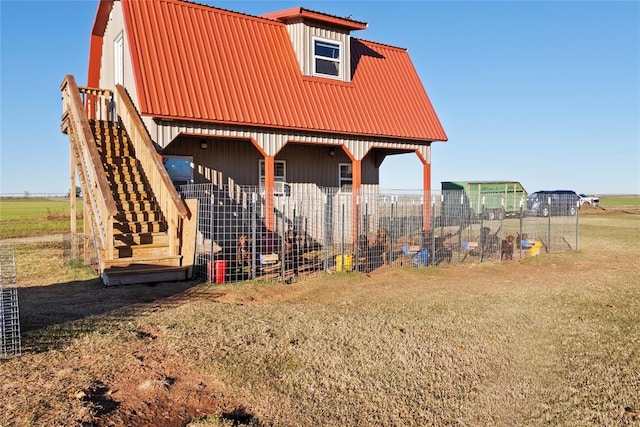 rear view of property with an outdoor structure