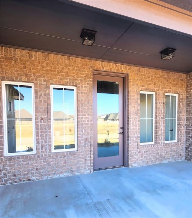 entrance to property featuring a patio