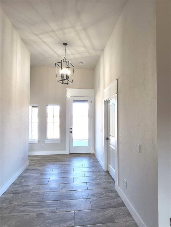 entryway with a healthy amount of sunlight and an inviting chandelier