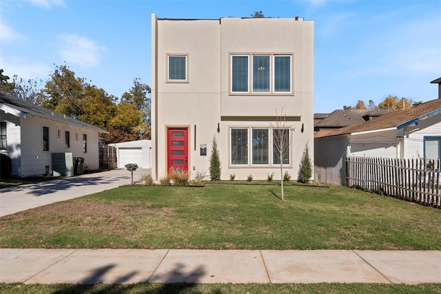 view of front of house featuring an outdoor structure, a front yard, and a garage