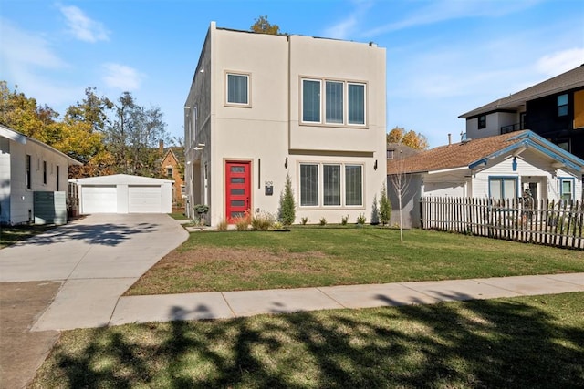 view of front of property featuring a front yard, a garage, and an outdoor structure