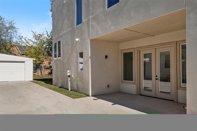 exterior space featuring a garage and french doors