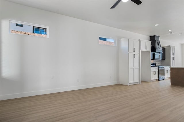 unfurnished living room featuring ceiling fan and light hardwood / wood-style floors