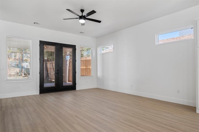 unfurnished room featuring ceiling fan, french doors, a healthy amount of sunlight, and light wood-type flooring