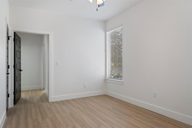 empty room featuring ceiling fan and light wood-type flooring