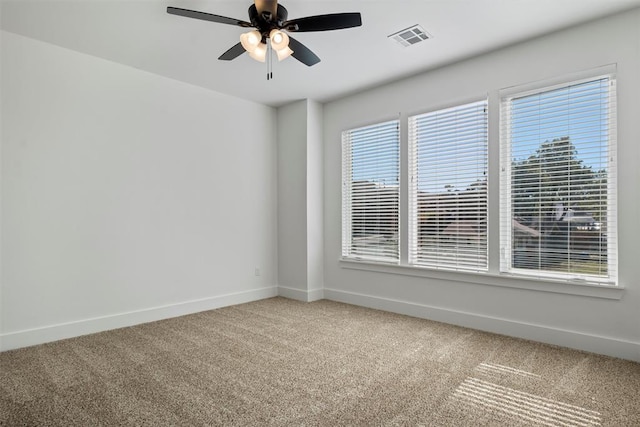 unfurnished room featuring carpet floors, a wealth of natural light, and ceiling fan