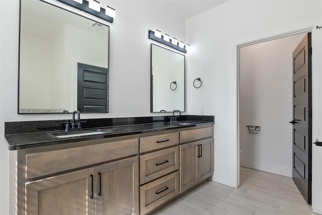 bathroom with hardwood / wood-style floors and vanity