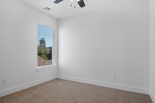 unfurnished room featuring ceiling fan and carpet