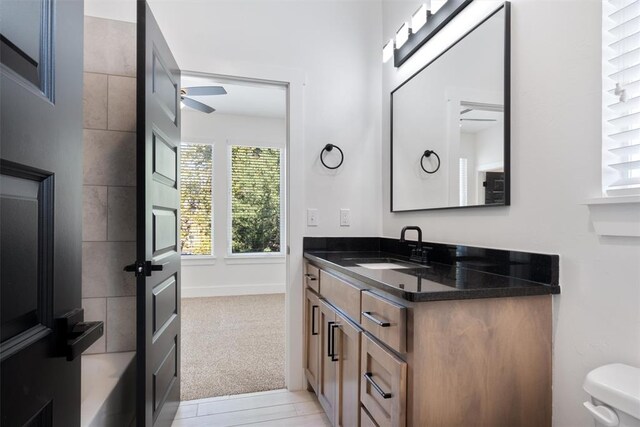 bathroom with ceiling fan, vanity, and toilet