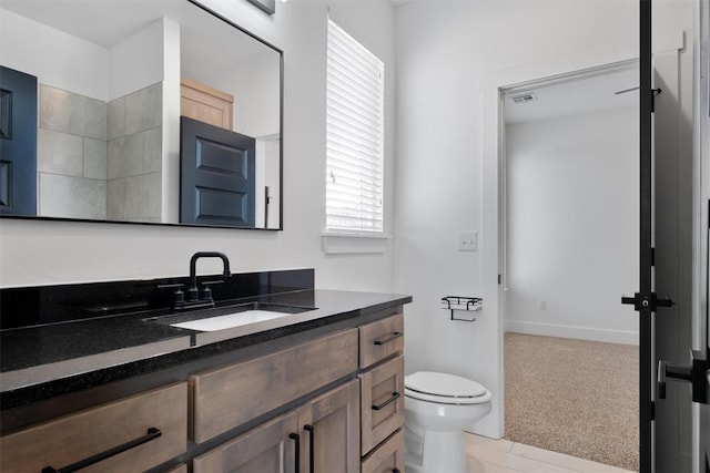 bathroom with vanity and toilet