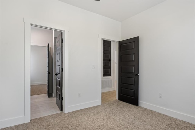 unfurnished bedroom featuring light wood-type flooring