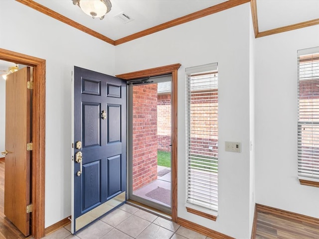 entrance foyer with light wood-type flooring and crown molding