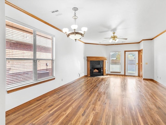 unfurnished living room featuring hardwood / wood-style floors, ceiling fan with notable chandelier, and crown molding