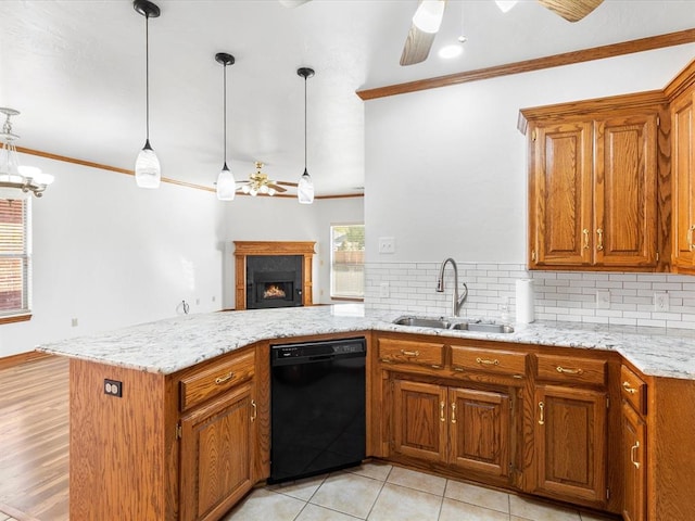 kitchen featuring kitchen peninsula, crown molding, sink, decorative light fixtures, and black dishwasher