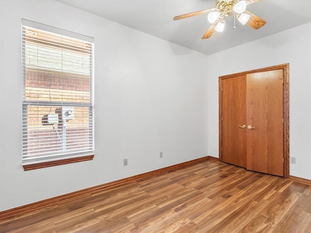 empty room featuring hardwood / wood-style flooring and ceiling fan