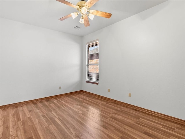 empty room with ceiling fan and hardwood / wood-style floors