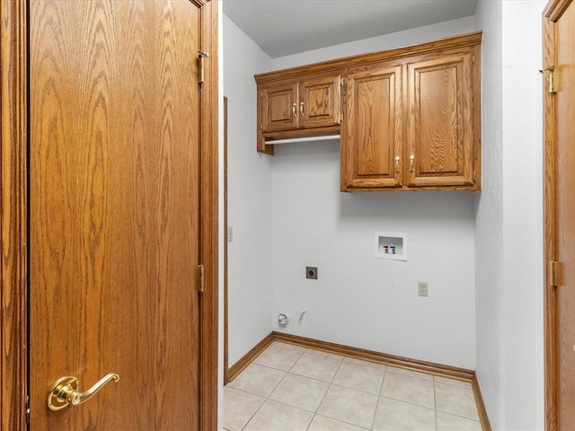 clothes washing area featuring hookup for an electric dryer, cabinets, light tile patterned floors, and washer hookup