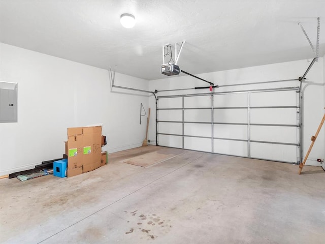 garage featuring electric panel and a garage door opener